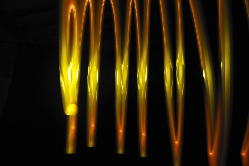 Abstract light trails made by molten metal against black background