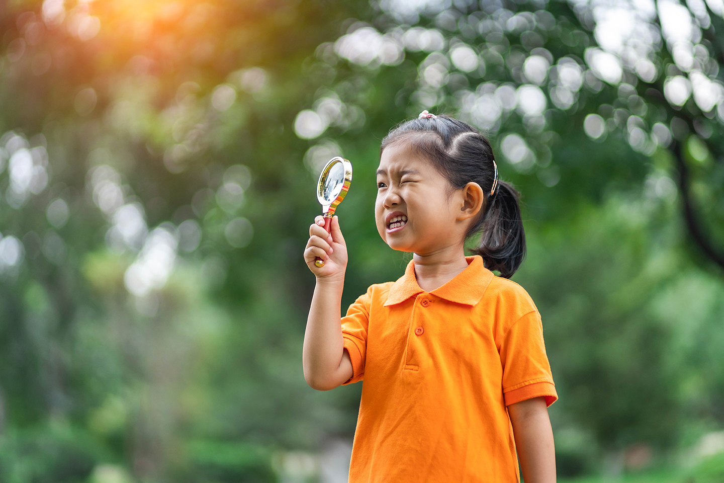 Girl uses magnifying glass discover and explore