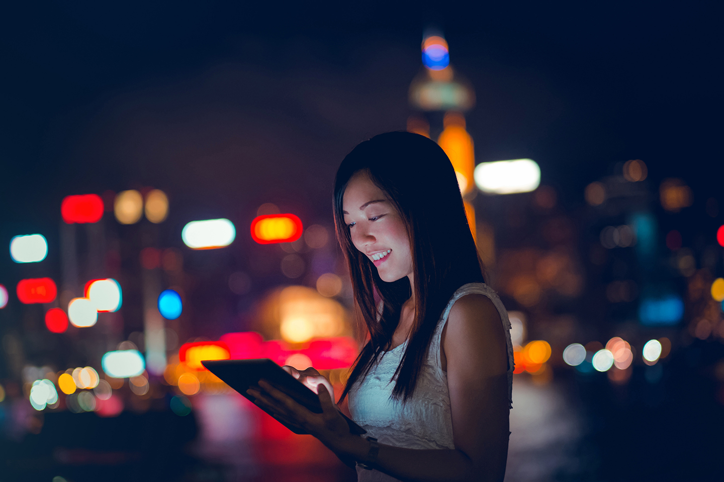 Young woman using tablet device in urban city